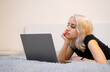 © Anana_go - The girl is watching a TV series on a laptop.