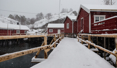 Wall Mural - red cabins of the Nusfjord fishing village in Lofoten archipelago on a snowy winter day