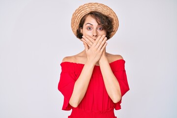 Sticker - Young hispanic woman wearing summer hat shocked covering mouth with hands for mistake. secret concept.