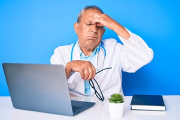 Sticker - Senior handsome man with gray hair wearing doctor uniform working using computer laptop tired rubbing nose and eyes feeling fatigue and headache. stress and frustration concept.