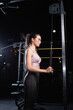 © LIGHTFIELD STUDIOS - side view of sportswoman in top and leggings working out on triceps extension machine