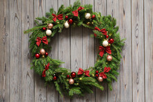Beautiful Christmas Wreath With Festive Decor On Wooden Background, Top View