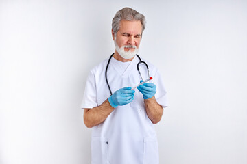 portrait of mature doctor man with sampling tube of infected person corona virus in laboratory, isolated on white background. coronavirus or covid-19 tube blood test concept