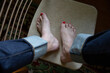 © Amanda Greene - woman's feet and cuffed denim jeans