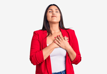 Sticker - Young beautiful brunette woman wearing elegant clothes smiling with hands on chest with closed eyes and grateful gesture on face. health concept.