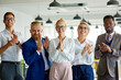 © alfa27 - happy business team congratulate colleague with a good job for making successful project, look at camera smiling and clapping hands