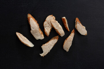 Wall Mural - Closeup of chicken breast chunks on dark