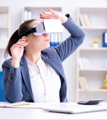 Businesswoman with virtual reality glasses in office