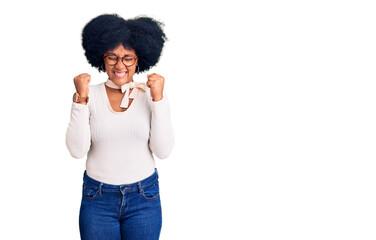 Sticker - Young african american girl wearing casual clothes and glasses excited for success with arms raised and eyes closed celebrating victory smiling. winner concept.