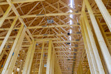 Fototapeta Most - Interior with wood framing beam of new house under construction beam wood