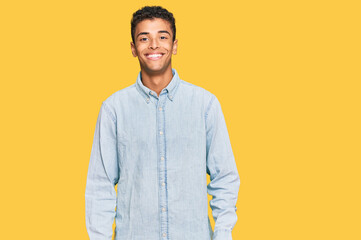 Young handsome african american man wearing casual clothes with a happy and cool smile on face. lucky person.