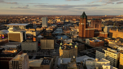 Aerial view of American city at sunset. Modern buildings, skyscrapers. Cloudy sky, cityscape. Milwaukee, Wisconsin