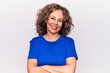 © Krakenimages.com - Middle age beautiful brunette woman wearing blue t-shirt standing over white background happy face smiling with crossed arms looking at the camera. Positive person.