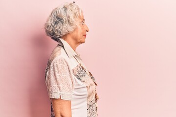 Poster - Senior grey-haired woman wearing casual clothes looking to side, relax profile pose with natural face with confident smile.