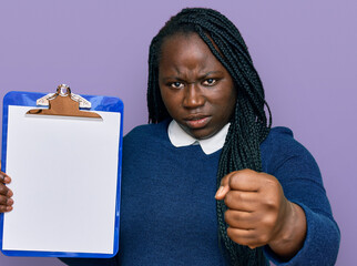 Sticker - Young black woman with braids holding clipboard with blank space annoyed and frustrated shouting with anger, yelling crazy with anger and hand raised