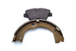two kinds asbestos brake pads for disc brakes and shoe for drum brakes, replacement spare parts of the car brake system isolated on white background, nobody.