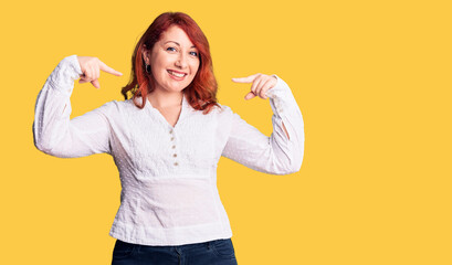 Sticker - Young beautiful redhead woman wearing casual shirt looking confident with smile on face, pointing oneself with fingers proud and happy.