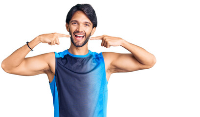 Poster - Handsome hispanic man wearing sportswear smiling cheerful showing and pointing with fingers teeth and mouth. dental health concept.