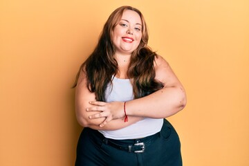 Plus size caucasian young woman wearing casual clothes happy face smiling with crossed arms looking at the camera. positive person.