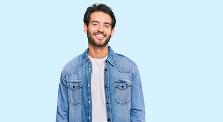 Sticker - Young hispanic man wearing casual clothes with a happy and cool smile on face. lucky person.