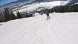 Group of fun people skiing downhill on beautiful snowy mountain in forest landscape. Winter sports. Vacation at ski resort. Concept of active life.