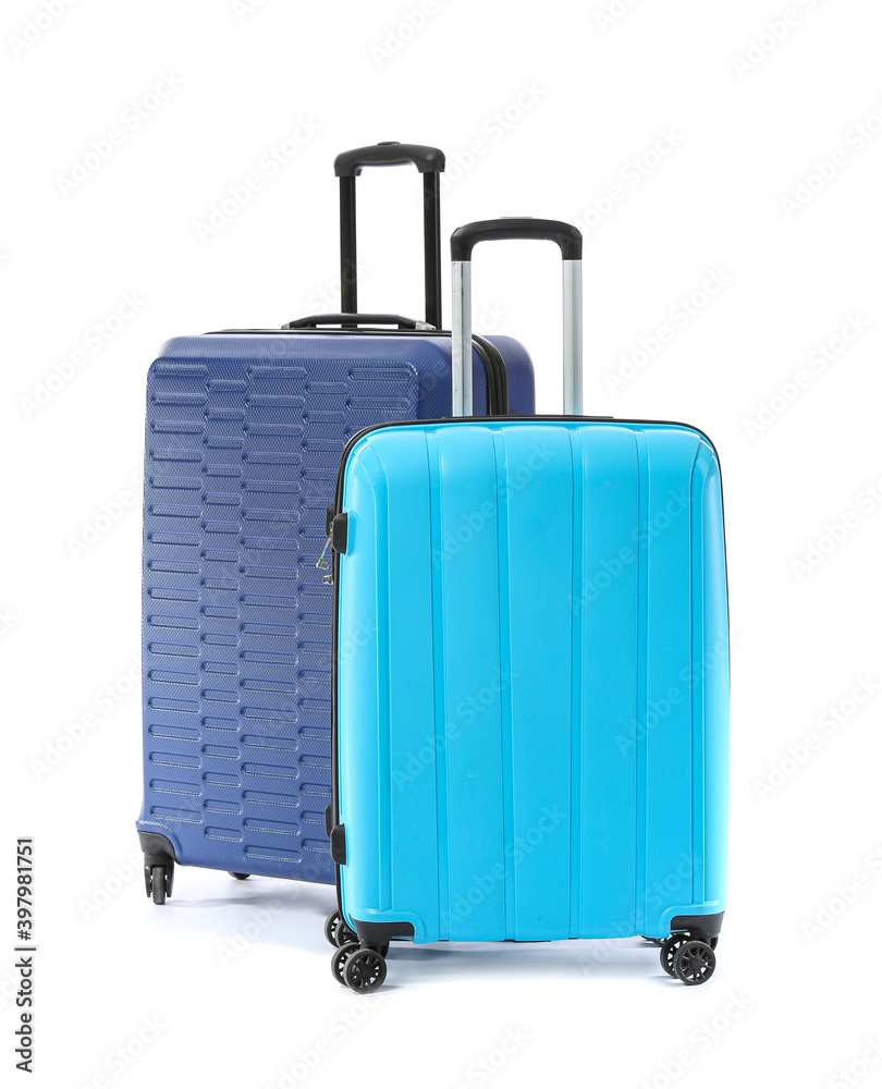 Packed suitcases on white background