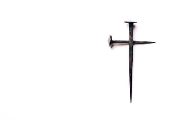 Cross made with rusty nails and drops of blood on white background. Copy space. Good Friday, Easter day. Christian backdrop. Biblical faith, gospel, salvation concept. Crucifixion of Jesus Christ