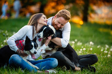 Wall Mural - Romantic happy couple in love enjoying their time with pets in nature