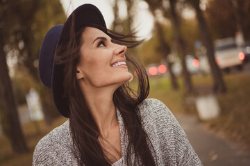 Sticker - Photo portrait of pretty girl laughing walking in the evening city street in autumn wearing casual grey clothes