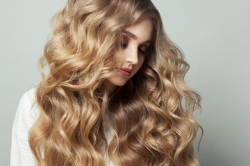 Wall Mural - portrait of perfect blonde woman with healthy curly hairstyle on white