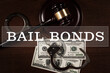 Judge gavel, handcuffs and money - Bail bonds services concept.