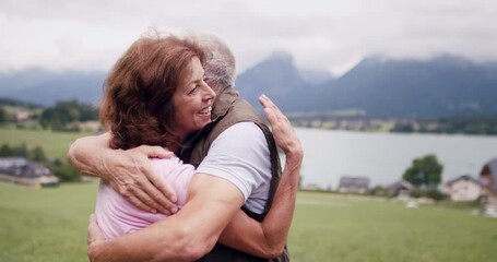 Sticker - Senior pensioner couple hiking in nature, hugging.