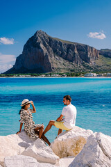 couple men and woman mid age on vacation at the Italian Island Sicily visiting the beach of San Vito Lo Capo. Sicilia Italy