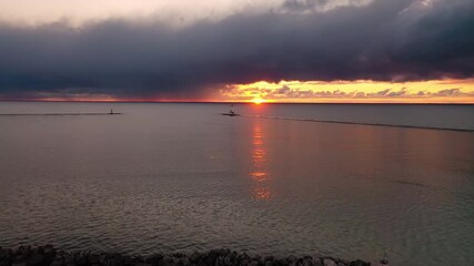 Wall Mural - beautiful sunset aerial panning in towards the white colored ludington breakwater lighthouse with pi