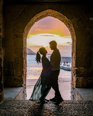 Wall Mural - couple on vacation Sicily visiting the old town of Cefalu,sunset at the beach of Cefalu Sicily, old town of Cefalu Sicilia panoramic view at the colorful village.Italy