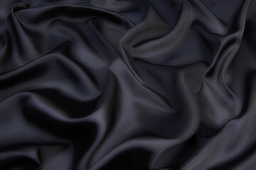 Abstract black color silk chiffon fabric texture. A mockup of silk tissue as background at  the artistic layout.