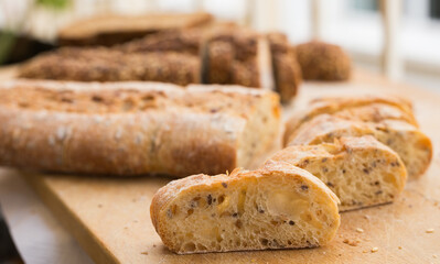 Wall Mural - fresh loaf of bread on wooden board