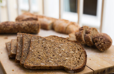 Wall Mural - fresh loaf of bread on wooden board