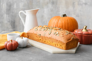 Tasty pumpkin pie on grunge background