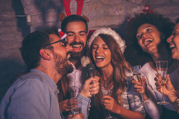 Wall Mural - Friends singing karaoke for New Year's Eve