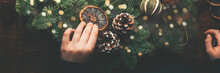 Process Of Making Christmas Wreath With Natural Zero Waste Ingredients Such As Dried Oranges, Dried Orange Slices, Pine Cones, Cinnamon Sticks, Eco Friendly Xmas, On Rustic Wooden Table, Banner Size