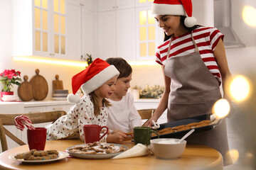 Sticker - Mother giving her cute little children freshly baked Christmas cookies in kitchen