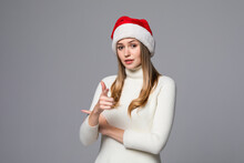 Young Beautiful Woman Wearing Christmas Hat Over Isolated Background Pointing To You And The Camera With Fingers, Smiling Positive And Cheerful