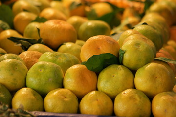 Wall Mural - Pile of ripe mandarins for sale at market. Organic fruits background. Food production industry.