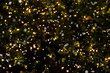 Christmas shiny dark blurry background with festive lights and snowflakes. Falling snow on a background of twinkling garlands.