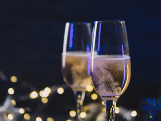 Wall Mural - Festive Christmas card, romantic evening, two glasses of champagne on a decorated background