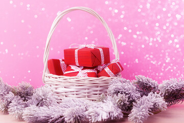 Wall Mural - Red gift boxes in handmade basket over holiday background with copy space