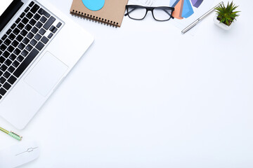 Poster - Laptop computer with office supplies on white background