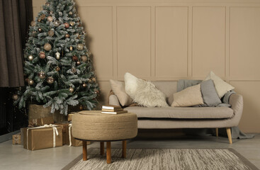 Decorated Christmas tree and gifts in beige living room