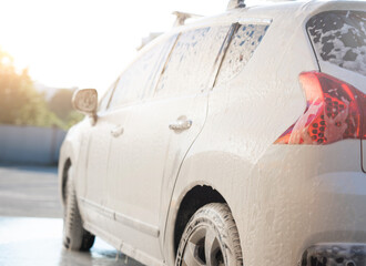 Wall Mural - Back view of car under foam on car wash station